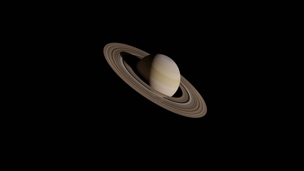 Representação detalhada de Saturno com seus anéis contra o fundo escuro do espaço.